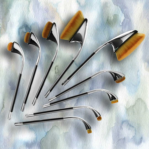 artis fluenta brush design collection brushe arranged in a spray pattern on watercolour paper