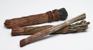 this is an image of very ancient brushes used by prehistoric or primitive artists. They are made of twigs and woven fibres.