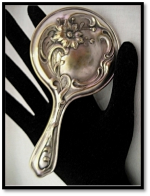 this is an image of an antique hand mirror from the middle 1800's when such mirrors became affordable for the average person.
