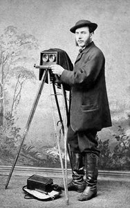 this is an image of an early photographer with his photo equipment from the middle 1800's.