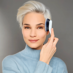 model holding digit oval 8 brush to the temple area of the face