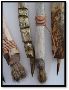 this is an image of several primative brushes that used twigs and cording and wads of animal hair to fashion art brushes.